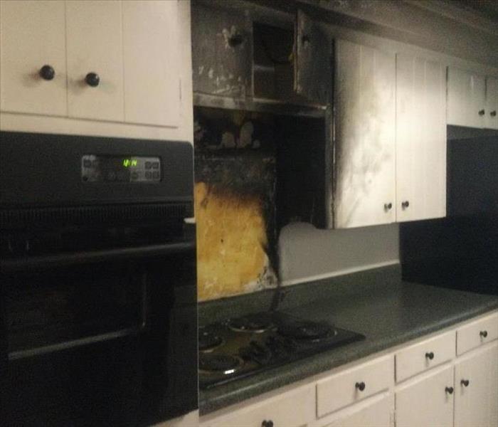 Aftermath of a kitchen fire.  Picture shows stove created damage to walls behind and above